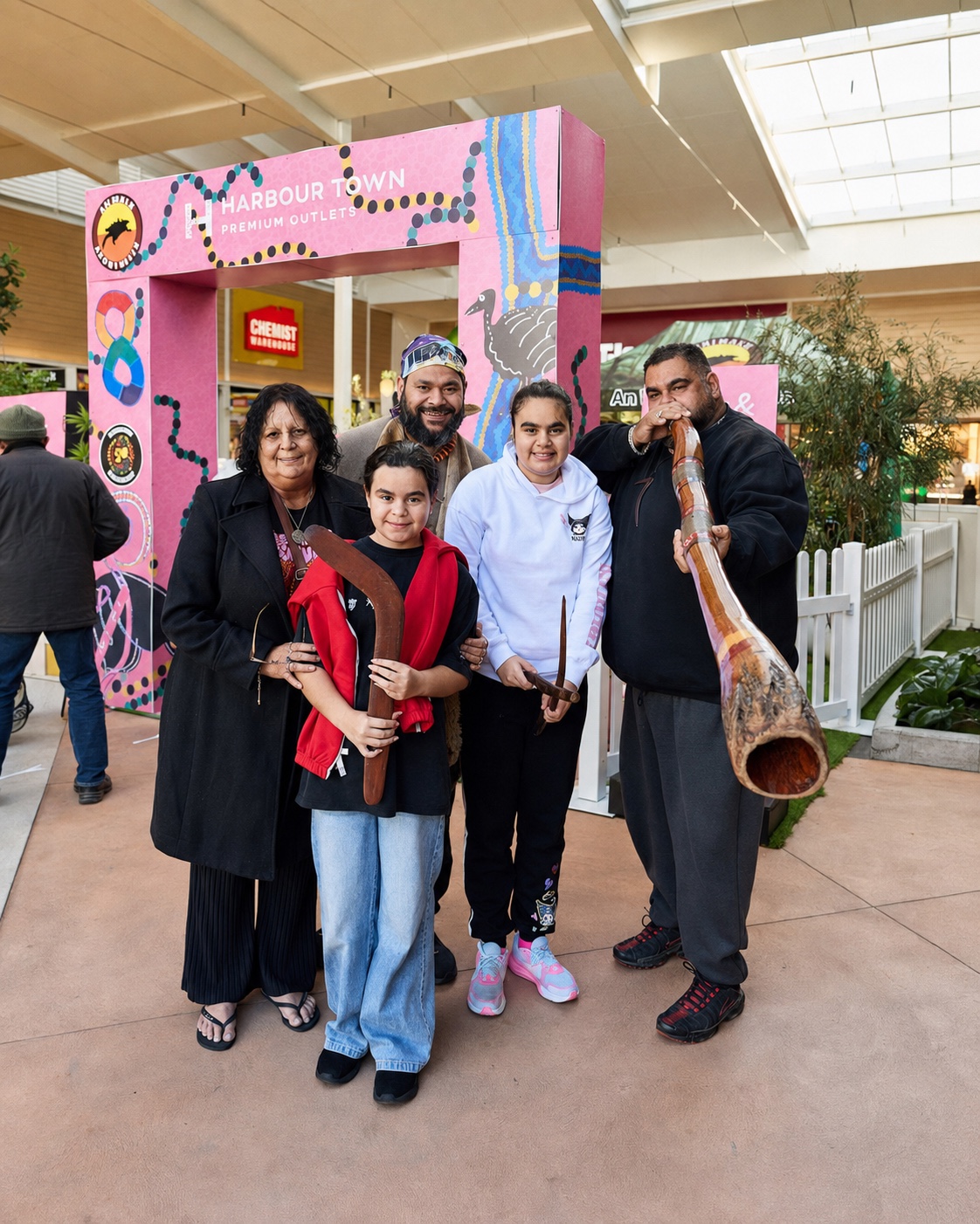 Petiola Wilson with family members holding cultural instruments at Harbour Town
